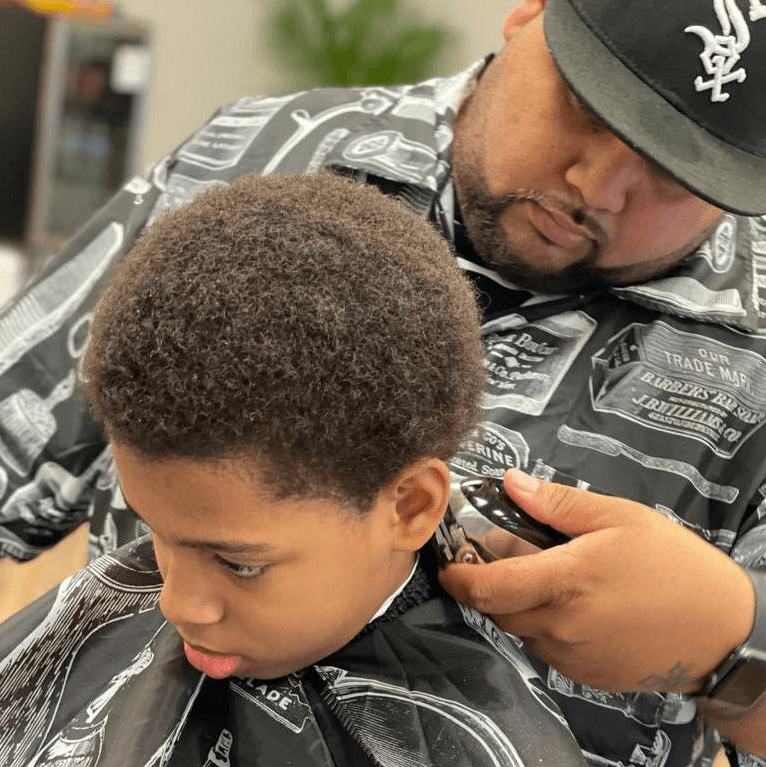 Rob cutting a young client's hair